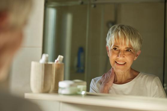 Person looking in the bathroom mirror